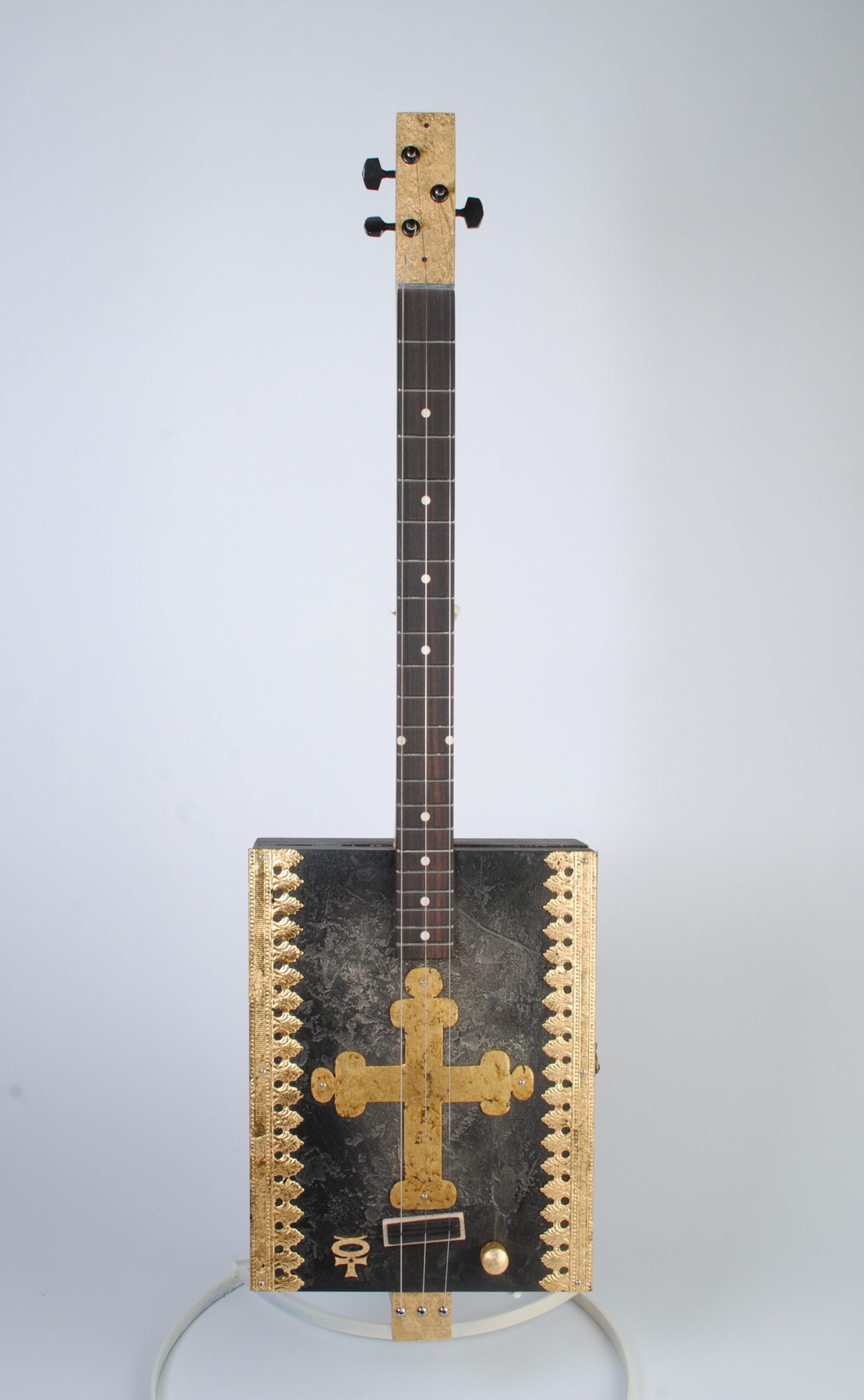 Gilded cross cigar box guitar front view