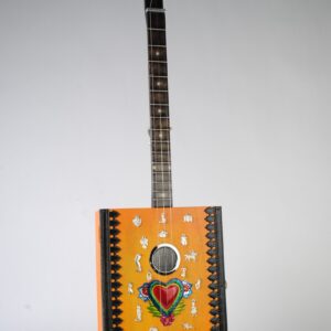 orange cigar box guitar with silver and painted tin milagros