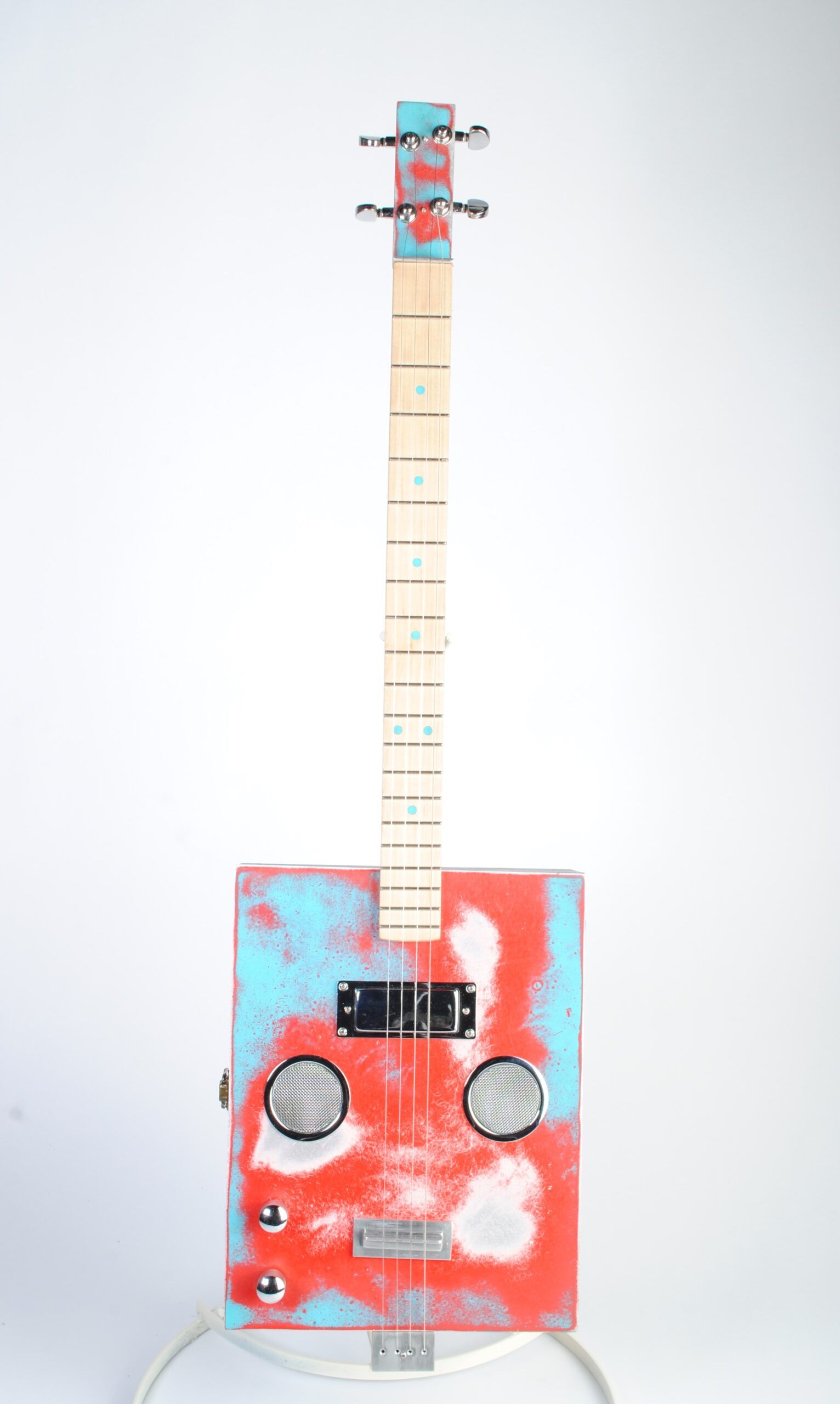 Closeup of the aqua/cherry guitar