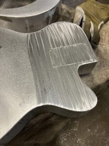 Resonator guitar body process. Brushing the aluminum