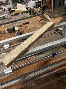 Guitar neck process. Fingerboard and neck unfinished