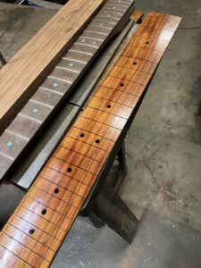 Guitar neck process. Koa fingerboard