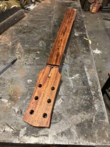 Guitar neck process. Koa neck with fingerboard glued