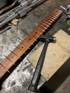 Guitar neck process. Setting the frets