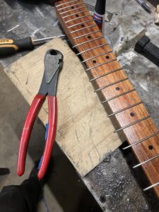 Guitar neck process. Trimming the fret ends