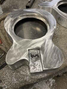 Resonator guitar body process. grinding complete